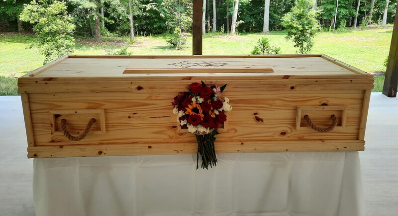 Peace Casket displayed for service with flowers
